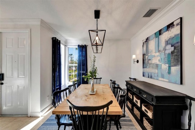 dining room with light tile patterned floors, visible vents, baseboards, and ornamental molding