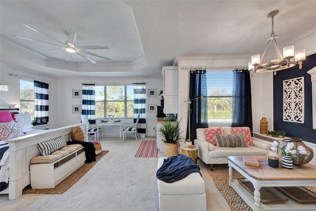 living room featuring plenty of natural light, ceiling fan with notable chandelier, crown molding, and a raised ceiling