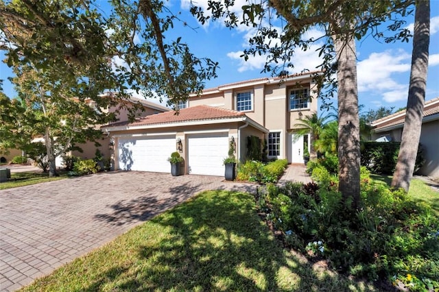 view of front facade with a garage, decorative driveway, a tile roof, and stucco siding