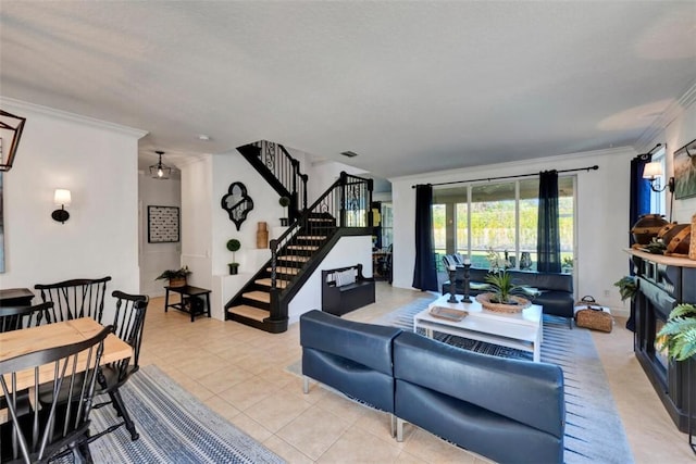 living area with visible vents, light tile patterned flooring, ornamental molding, and stairs