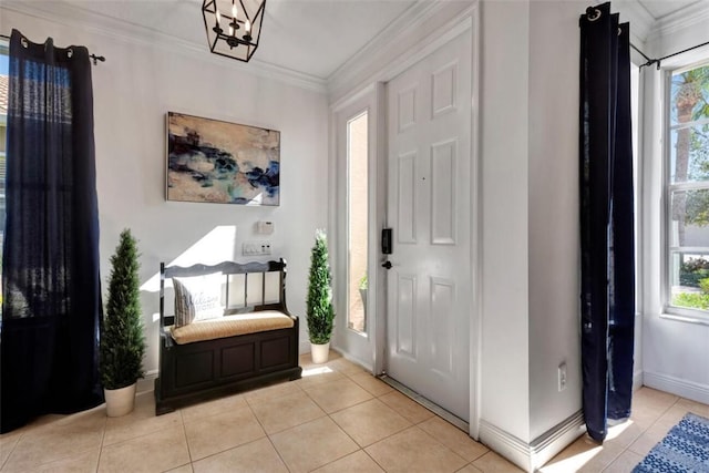 entrance foyer with light tile patterned floors, plenty of natural light, and ornamental molding