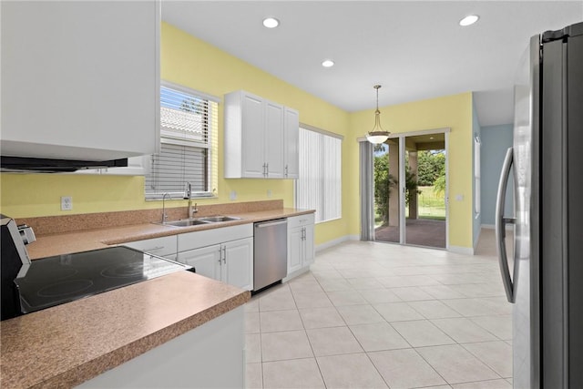 1877 Grey Falcon Cir SW, Vero Beach, FL 32962 - kitchen featuring stainless steel appliances, a sink, white cabinets, decorative light fixtures, and baseboards