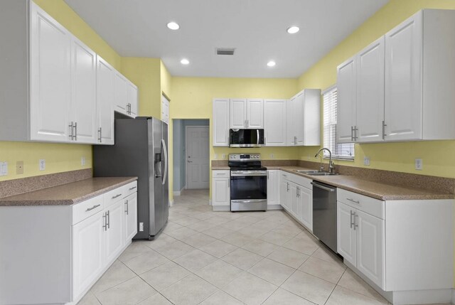 1877 Grey Falcon Cir SW, Vero Beach, FL 32962 - kitchen with appliances with stainless steel finishes, a sink, white cabinetry, and recessed lighting