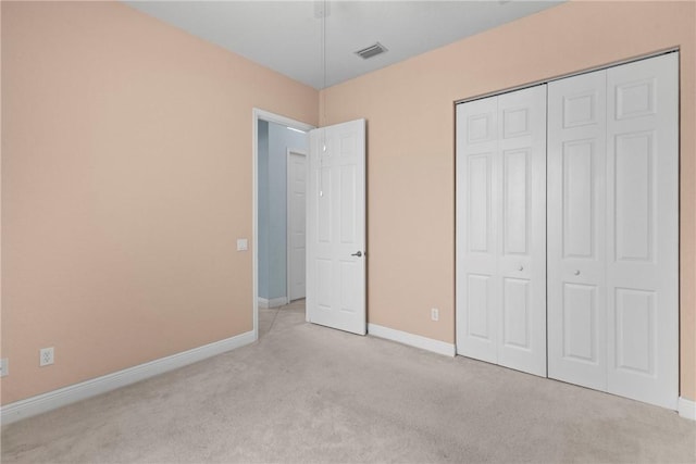 1877 Grey Falcon Cir SW, Vero Beach, FL 32962 - unfurnished bedroom with carpet floors, baseboards, and a closet