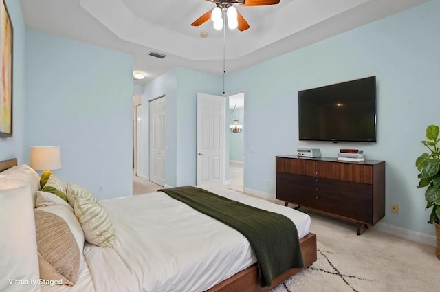 1877 Grey Falcon Cir SW, Vero Beach, FL 32962 - bedroom with light colored carpet, baseboards, a ceiling fan, a closet, and a tray ceiling