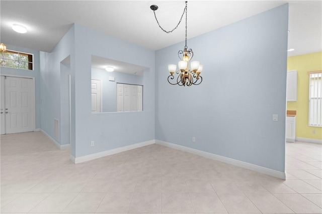 1877 Grey Falcon Cir SW, Vero Beach, FL 32962 - spare room with a chandelier, baseboards, and light tile patterned flooring