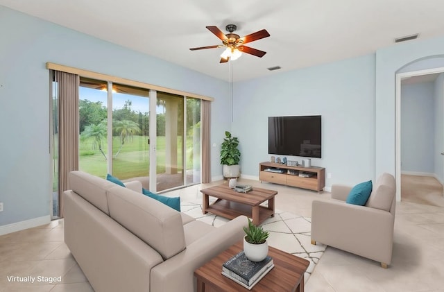 1877 Grey Falcon Cir SW, Vero Beach, FL 32962 - living room with a ceiling fan, light tile patterned flooring, and baseboards