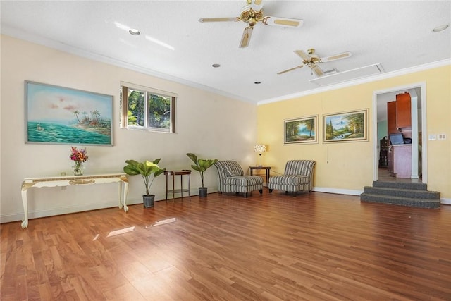 living area with hardwood / wood-style floors, ornamental molding, and ceiling fan