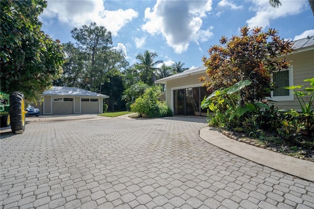 view of side of home featuring a garage and an outdoor structure