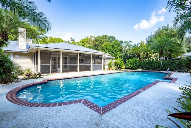 view of pool featuring a sunroom and a patio area