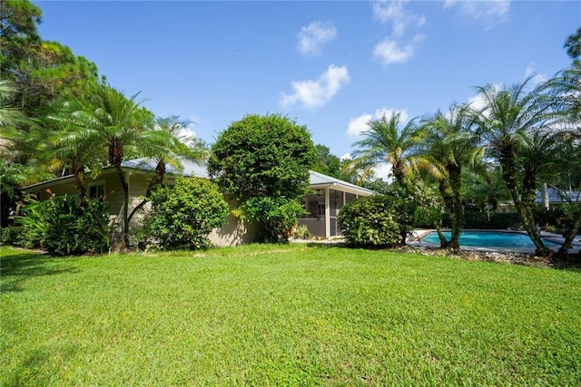 view of yard with a sunroom