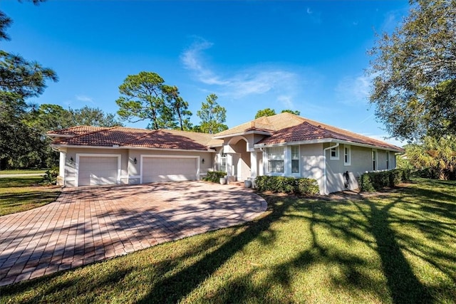 view of front of home featuring a garage and a front lawn