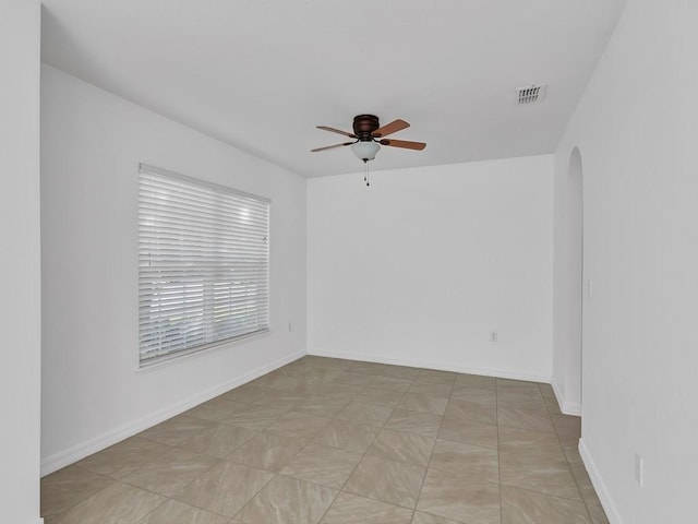 5985 Ridge Lake Cir, Vero Beach, FL 32967 - empty room with arched walkways and a ceiling fan
