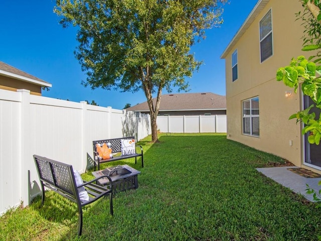 5985 Ridge Lake Cir, Vero Beach, FL 32967 - fenced backyard featuring an outdoor fire pit