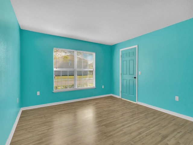 5985 Ridge Lake Cir, Vero Beach, FL 32967 - spare room featuring wood finished floors and baseboards