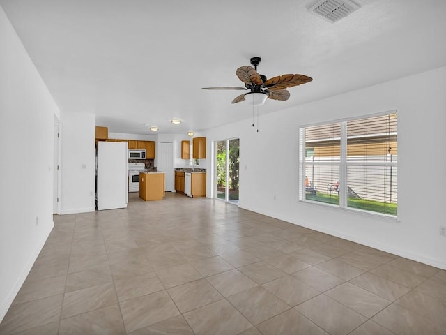 5985 Ridge Lake Cir, Vero Beach, FL 32967 - unfurnished living room with baseboards and ceiling fan