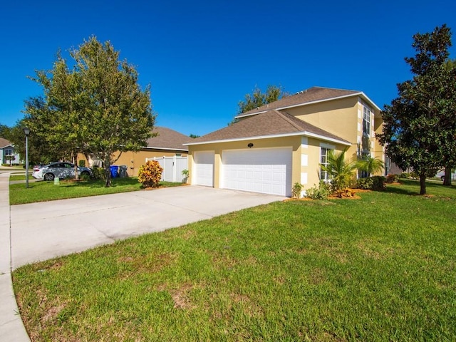 5985 Ridge Lake Cir, Vero Beach, FL 32967 - view of front of house featuring stucco siding, an attached garage, a front lawn, and driveway