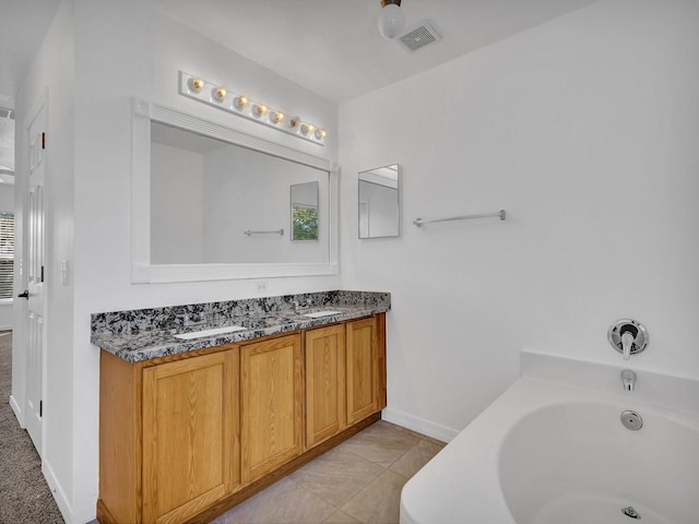 5985 Ridge Lake Cir, Vero Beach, FL 32967 - bathroom with double vanity and a garden tub