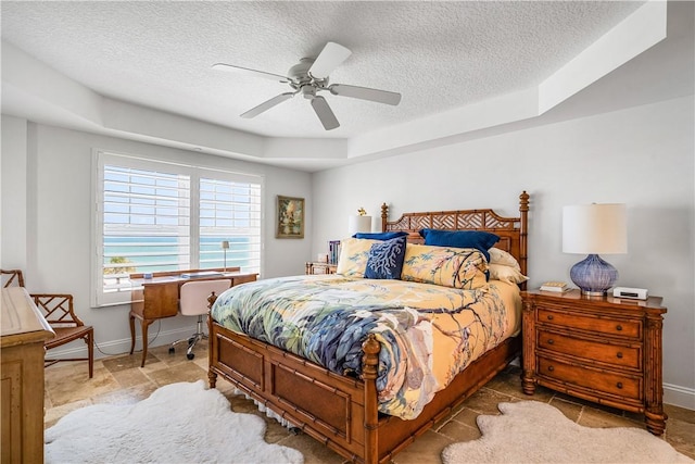 2700 Ocean Dr Unit 405, Vero Beach, FL 32963 - bedroom with baseboards, a ceiling fan, a tray ceiling, and a textured ceiling