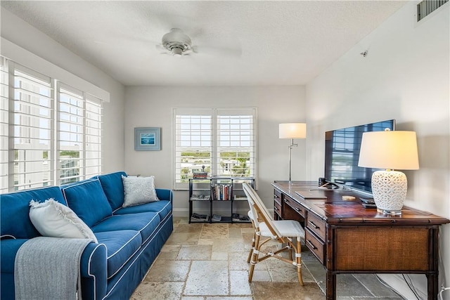 2700 Ocean Dr Unit 405, Vero Beach, FL 32963 - home office with visible vents, baseboards, stone tile flooring, and ceiling fan