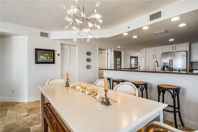 2700 Ocean Dr Unit 405, Vero Beach, FL 32963 - dining room with baseboards, visible vents, and a textured ceiling