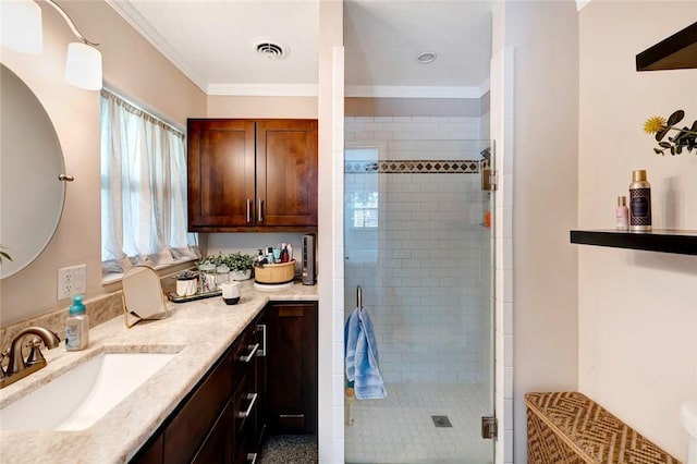 bathroom with walk in shower, vanity, and ornamental molding