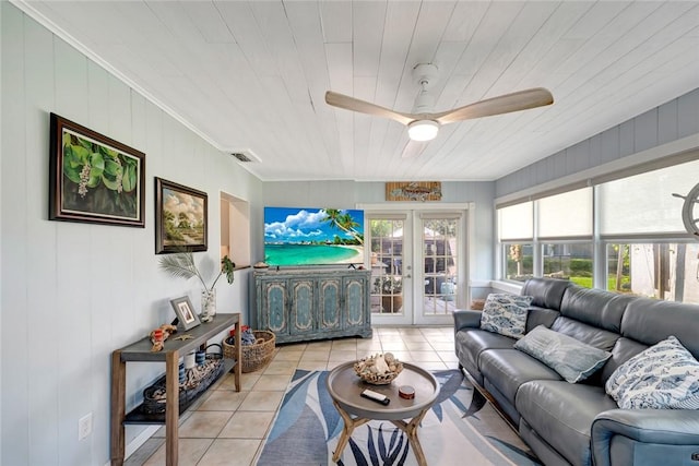 living room featuring wooden ceiling, french doors, wooden walls, ceiling fan, and light tile patterned flooring