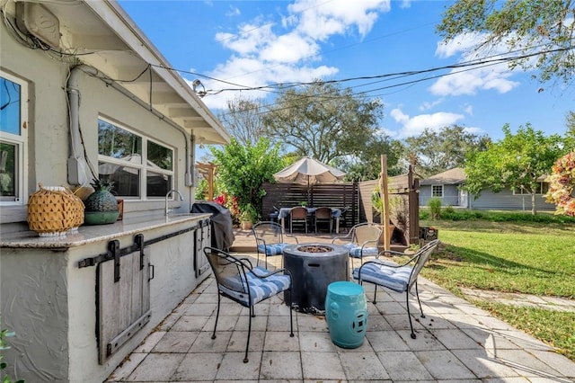 view of patio / terrace featuring a fire pit and a grill