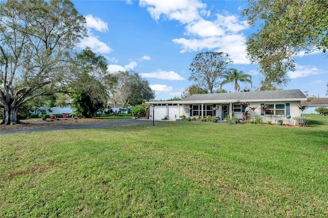 view of front of property with a front lawn and a garage