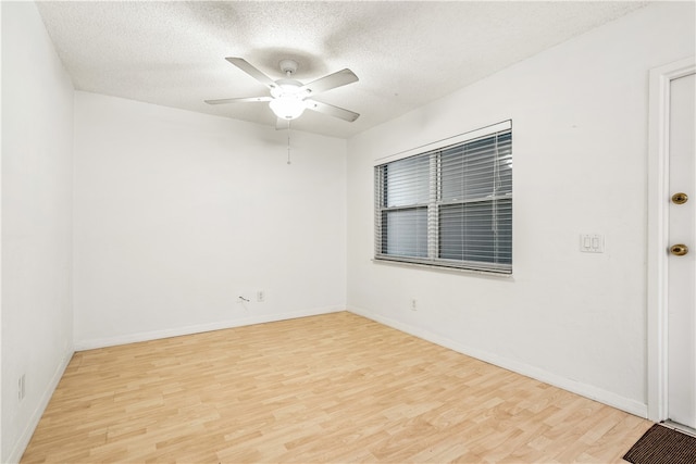 empty room featuring ceiling fan, a textured ceiling, and light hardwood / wood-style floors