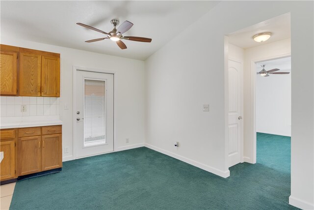 interior space with tasteful backsplash, ceiling fan, and dark carpet