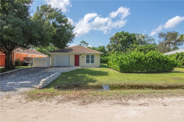 single story home with a garage and a front yard