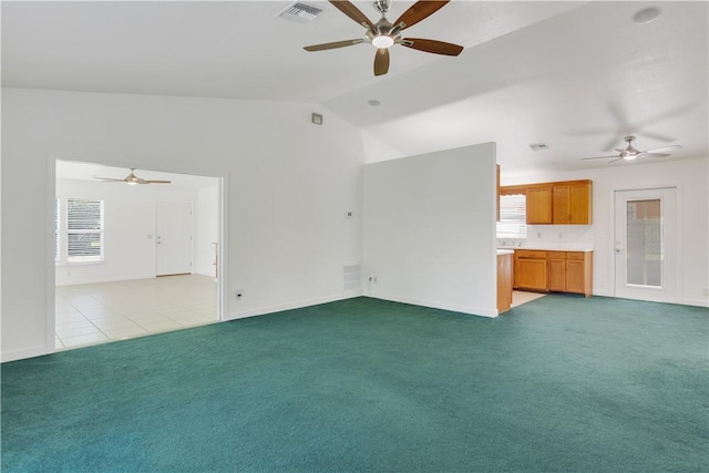 unfurnished living room with lofted ceiling, light carpet, and ceiling fan