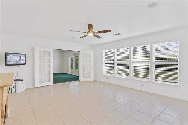 tiled spare room with french doors, ceiling fan, and plenty of natural light