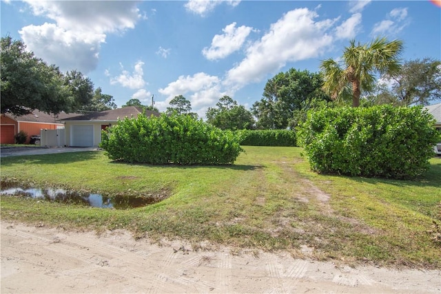 view of yard with a garage and a water view