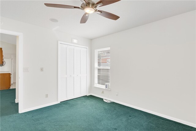 unfurnished bedroom featuring white refrigerator, ceiling fan, a closet, and dark colored carpet