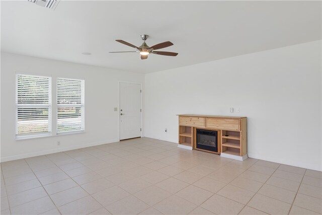 unfurnished living room with light tile patterned floors and ceiling fan