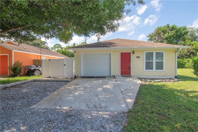 ranch-style home with a garage and a front yard