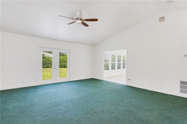 carpeted empty room featuring french doors, ceiling fan, a healthy amount of sunlight, and vaulted ceiling