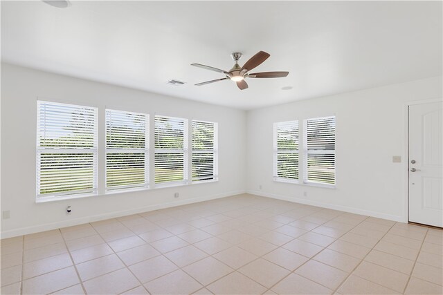 tiled empty room with ceiling fan