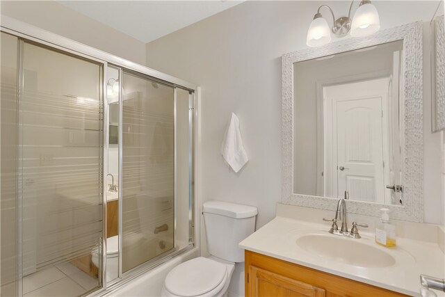 full bathroom with vanity, toilet, and combined bath / shower with glass door