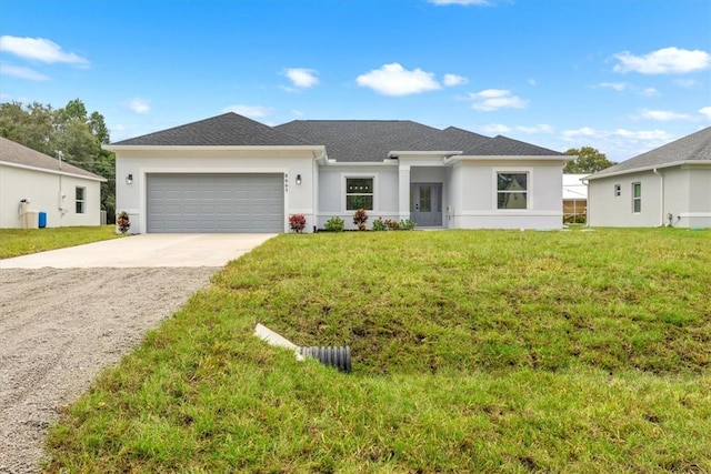 view of front of house with a garage and a front lawn