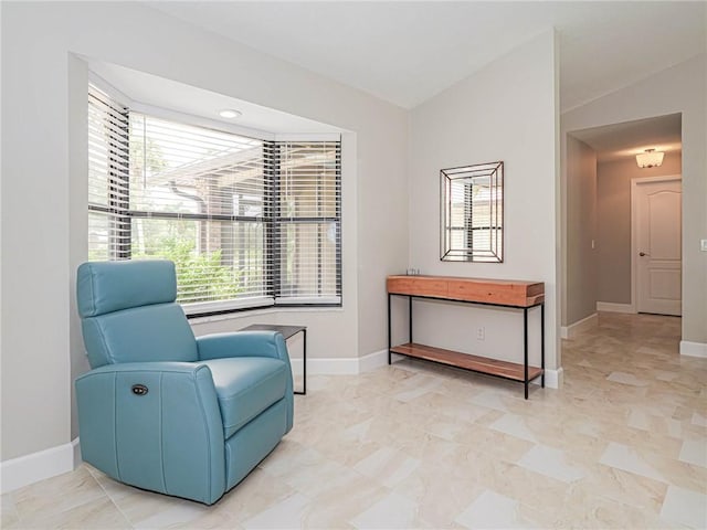 sitting room featuring lofted ceiling