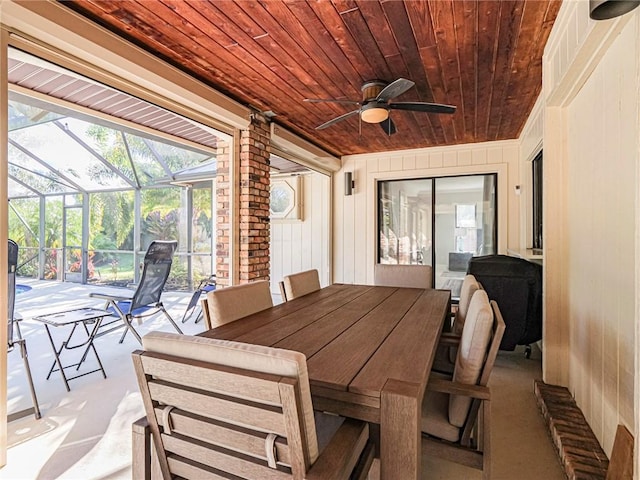 sunroom featuring wooden ceiling and ceiling fan