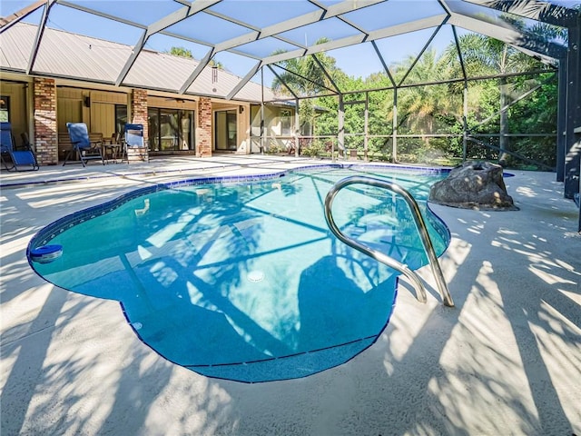 view of pool with a lanai and a patio