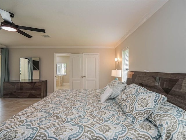 bedroom featuring ornamental molding, connected bathroom, and multiple windows