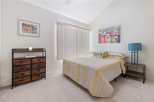 bedroom featuring carpet, lofted ceiling, and baseboards