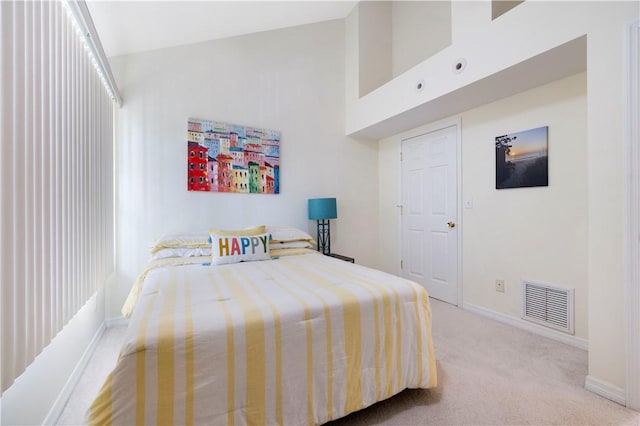 bedroom with carpet flooring, baseboards, and high vaulted ceiling