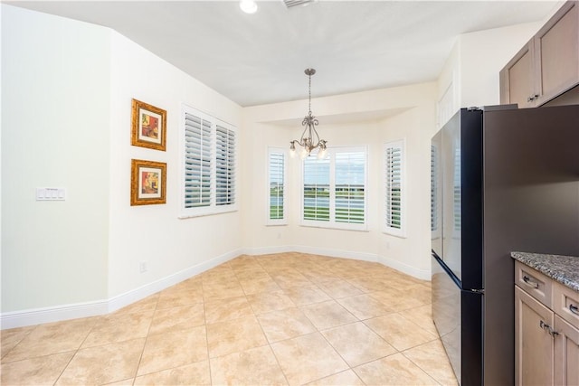 1122 4th Ln SW, Vero Beach, FL 32962 - unfurnished dining area featuring a chandelier, light tile patterned flooring, and baseboards