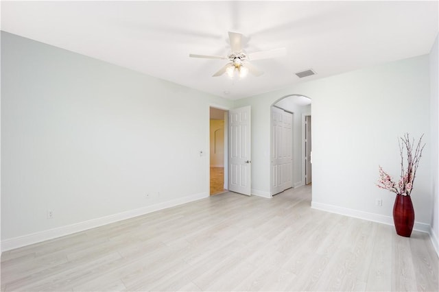 1122 4th Ln SW, Vero Beach, FL 32962 - unfurnished room featuring arched walkways, light wood finished floors, ceiling fan, and baseboards